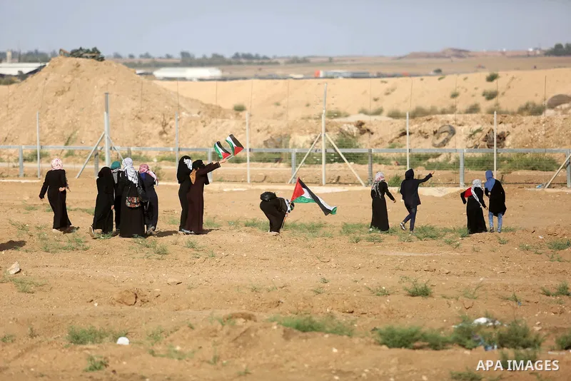 Palestinian women gather during a protest where Palestinians demand the right to return to their homeland along the border with Israel east of Gaza City on July 3, 2018. Photo by Ashraf Amra