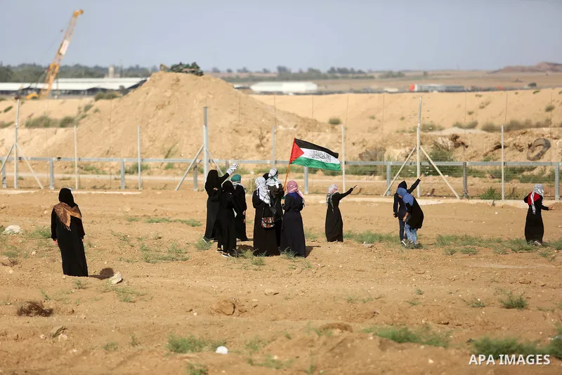 Palestinian women gather during a protest where Palestinians demand the right to return to their homeland along the border with Israel east of Gaza City on July 3, 2018. Photo by Ashraf Amra