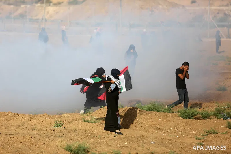 Palestinian women gather during a protest where Palestinians demand the right to return to their homeland along the border with Israel east of Gaza City on July 3, 2018. Photo by Ashraf Amra