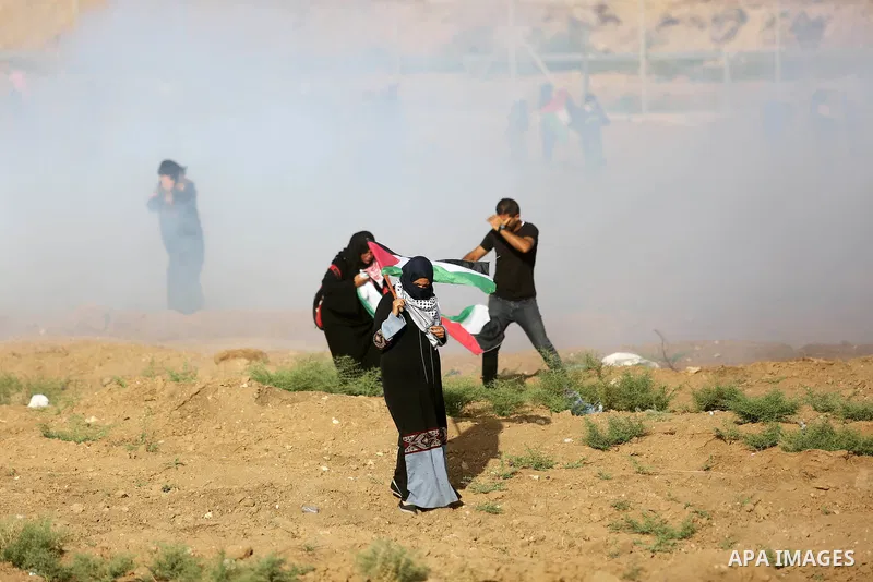 Palestinian women gather during a protest where Palestinians demand the right to return to their homeland along the border with Israel east of Gaza City on July 3, 2018. Photo by Ashraf Amra