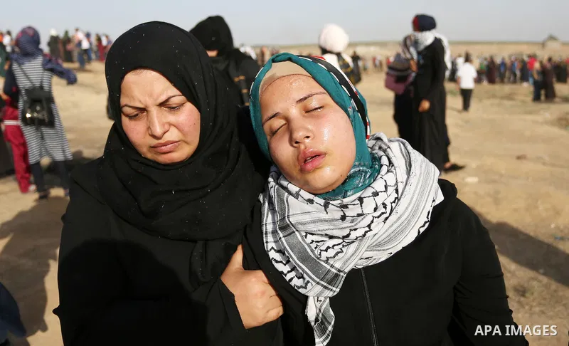 Palestinian women gather during a protest where Palestinians demand the right to return to their homeland along the border with Israel east of Gaza City on July 3, 2018. Photo by Ashraf Amra