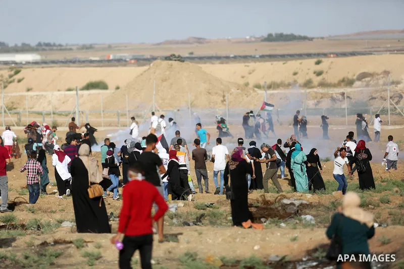 Palestinian women gather during a protest where Palestinians demand the right to return to their homeland along the border with Israel east of Gaza City on July 3, 2018. Photo by Ashraf Amra