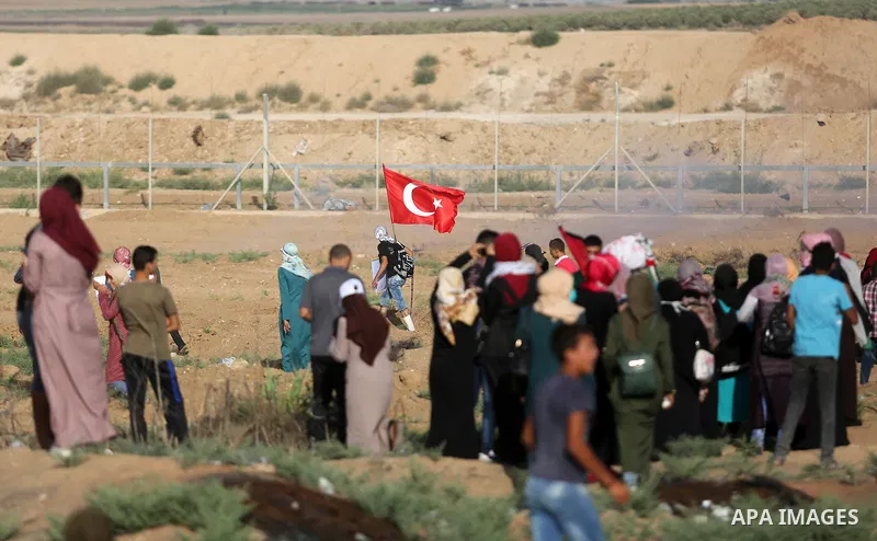 Palestinian women gather during a protest where Palestinians demand the right to return to their homeland along the border with Israel east of Gaza City on July 3, 2018. Photo by Ashraf Amra