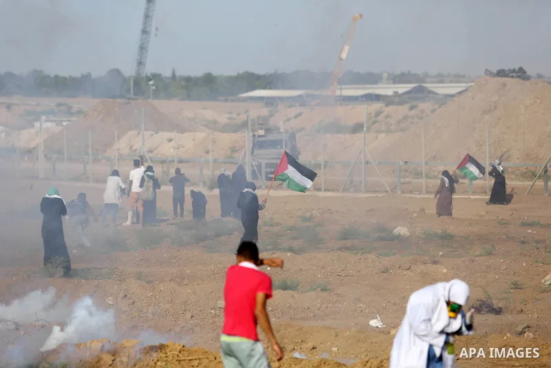 Palestinian women gather during a protest where Palestinians demand the right to return to their homeland along the border with Israel east of Gaza City on July 3, 2018. Photo by Ashraf Amra