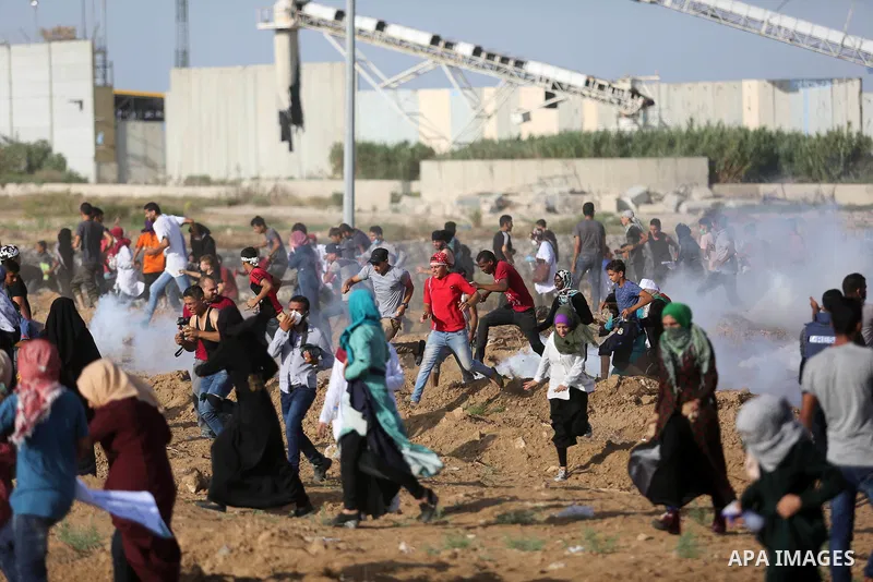 Palestinian women gather during a protest where Palestinians demand the right to return to their homeland along the border with Israel east of Gaza City on July 3, 2018. Photo by Ashraf Amra