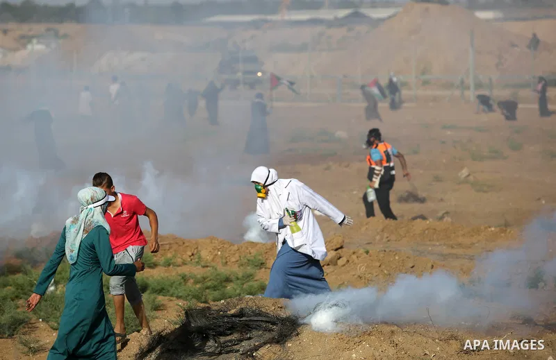 Palestinian women gather during a protest where Palestinians demand the right to return to their homeland along the border with Israel east of Gaza City on July 3, 2018. Photo by Ashraf Amra