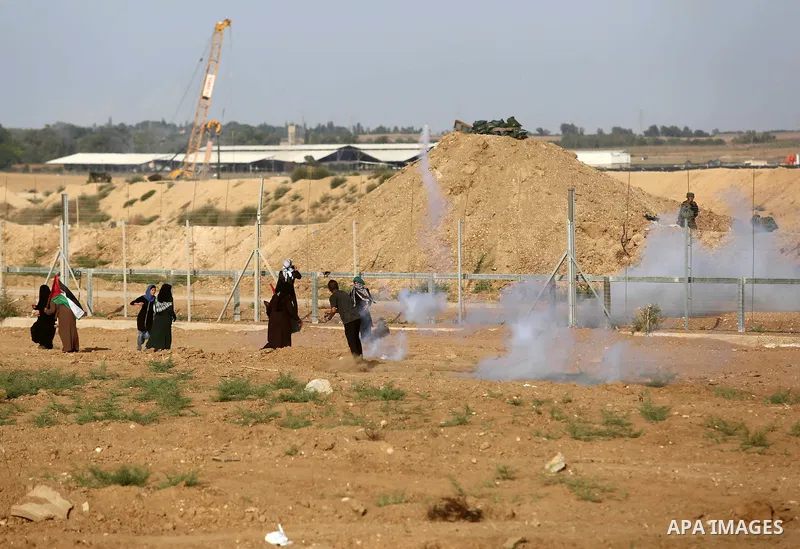 Palestinian women gather during a protest where Palestinians demand the right to return to their homeland along the border with Israel east of Gaza City on July 3, 2018. Photo by Ashraf Amra