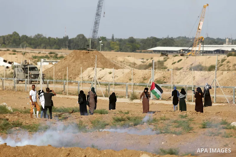 Palestinian women gather during a protest where Palestinians demand the right to return to their homeland along the border with Israel east of Gaza City on July 3, 2018. Photo by Ashraf Amra