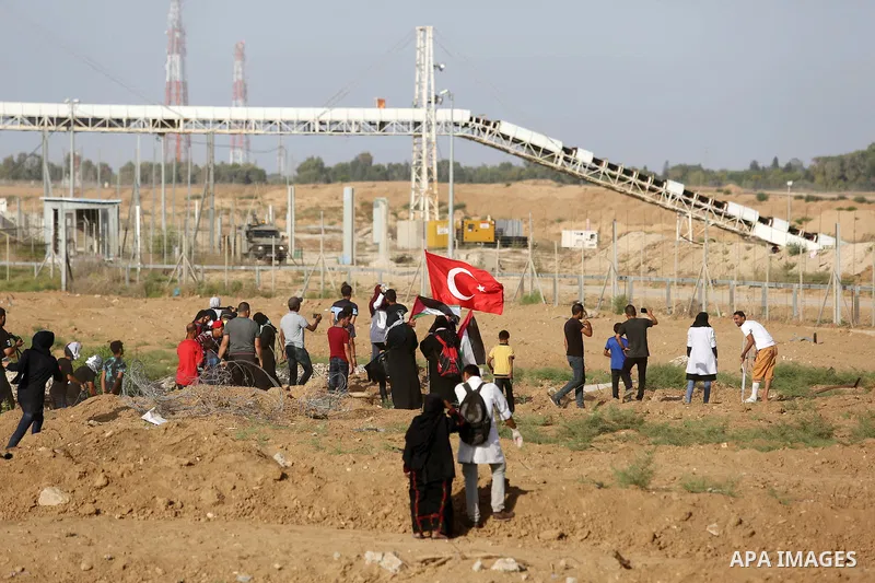 Palestinian women gather during a protest where Palestinians demand the right to return to their homeland along the border with Israel east of Gaza City on July 3, 2018. Photo by Ashraf Amra
