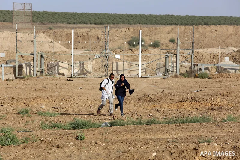 Palestinian medics help a female protester during a protest by Palestinian women where Palestinians demand the right to return to their homeland along the border with Israel east of Gaza City on July 3, 2018. Photo by At...