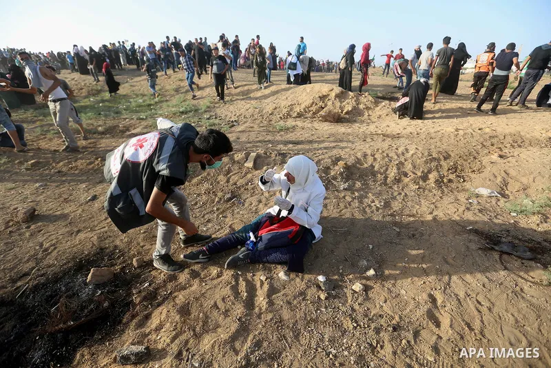 Palestinian women gather during a protest where Palestinians demand the right to return to their homeland along the border with Israel east of Gaza City on July 3, 2018. Photo by Atia Darwish