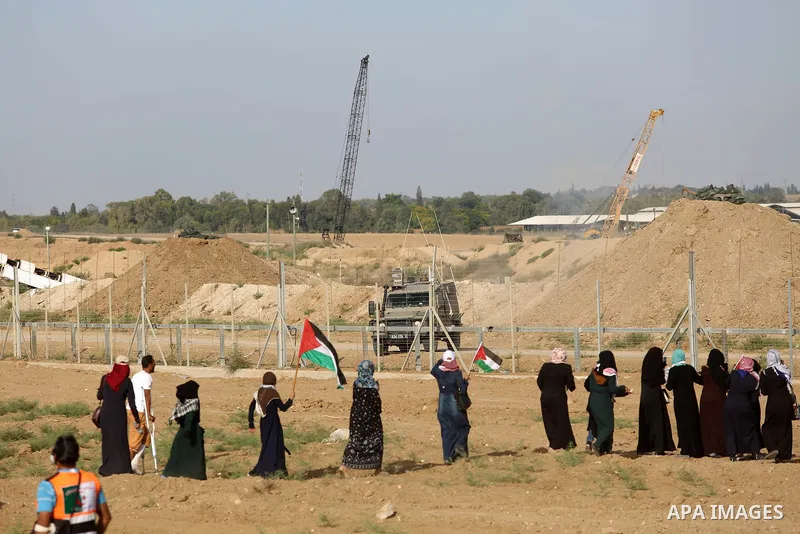 Palestinian women gather during a protest where Palestinians demand the right to return to their homeland along the border with Israel east of Gaza City on July 3, 2018. Photo by Atia Darwish
