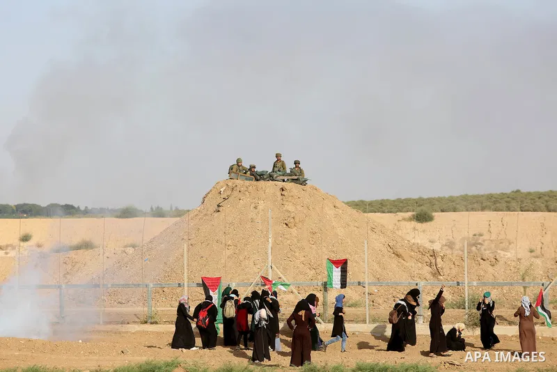 Palestinian women gather during a protest where Palestinians demand the right to return to their homeland along the border with Israel east of Gaza City on July 3, 2018. Photo by Atia Darwish