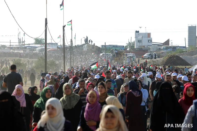 Palestinian women gather during a protest where Palestinians demand the right to return to their homeland along the border with Israel east of Gaza City on July 3, 2018. Photo by Atia Darwish