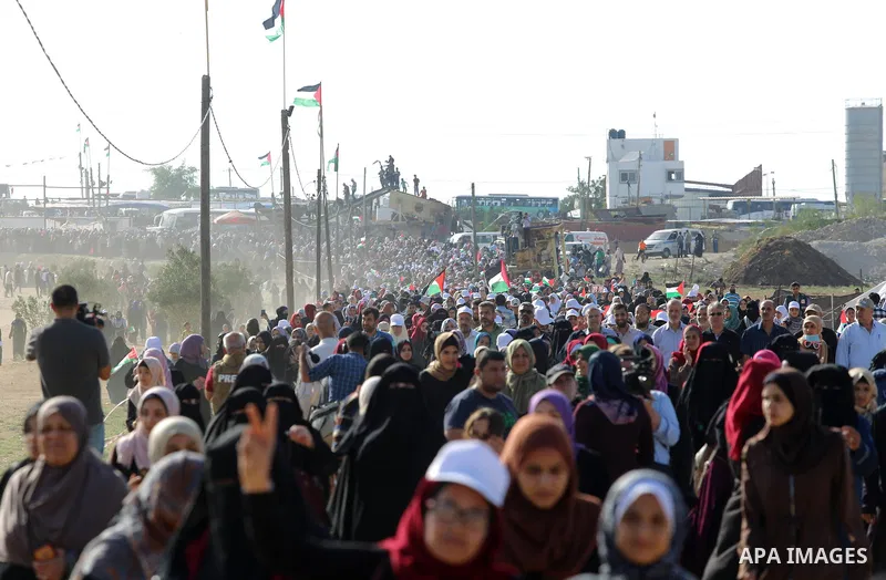 Palestinian women gather during a protest where Palestinians demand the right to return to their homeland along the border with Israel east of Gaza City on July 3, 2018. Photo by Atia Darwish