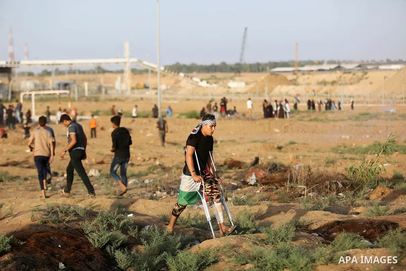 Protesters gather during a protest by Palestinian women where Palestinians demand the right to return to their homeland along the border with Israel east of Gaza City on July 3, 2018. Photo by Ashraf Amra