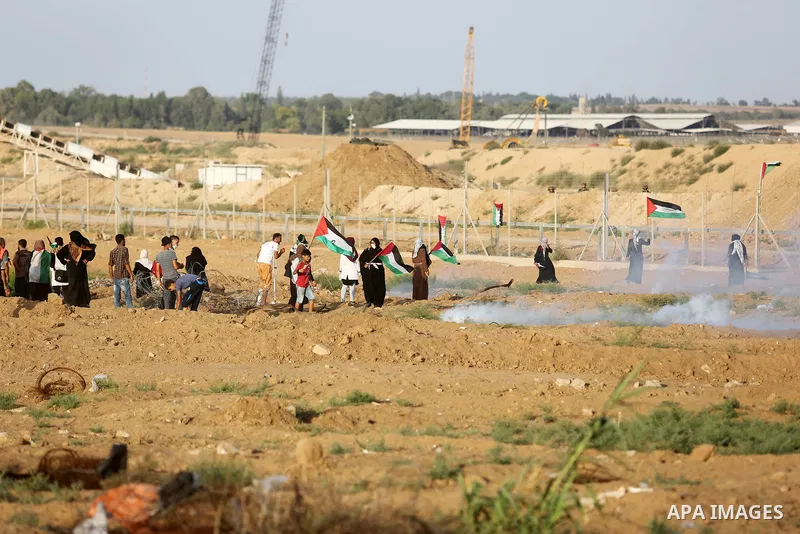 Protesters gather during a protest by Palestinian women where Palestinians demand the right to return to their homeland along the border with Israel east of Gaza City on July 3, 2018. Photo by Ashraf Amra