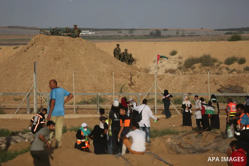 Protesters gather during a protest by Palestinian women where Palestinians demand the right to return to their homeland along the border with Israel east of Gaza City on July 3, 2018. Photo by Ashraf Amra