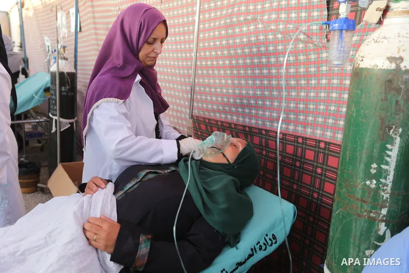 Palestinian Paramedics provide treatment for an injured protester during a protest by Palestinian women where Palestinians demand the right to return to their homeland along the border with Israel east of Gaza City on Ju...