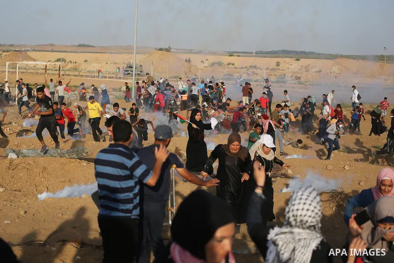 Protesters gather during a protest by Palestinian women where Palestinians demand the right to return to their homeland along the border with Israel east of Gaza City on July 3, 2018. Photo by Ashraf Amra