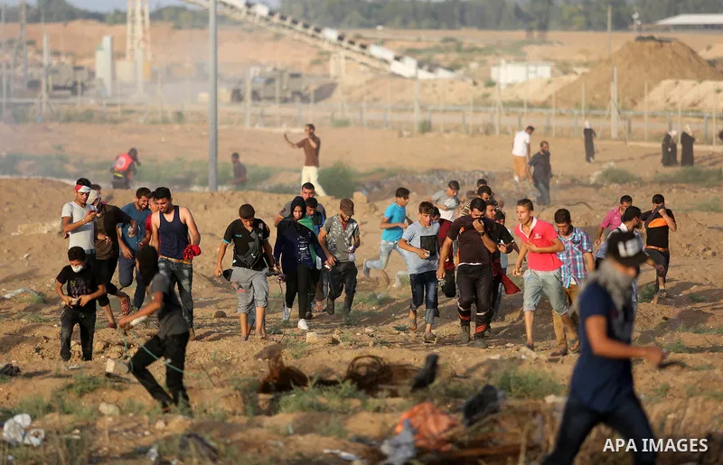 Protesters gather during a protest by Palestinian women where Palestinians demand the right to return to their homeland along the border with Israel east of Gaza City on July 3, 2018. Photo by Ashraf Amra