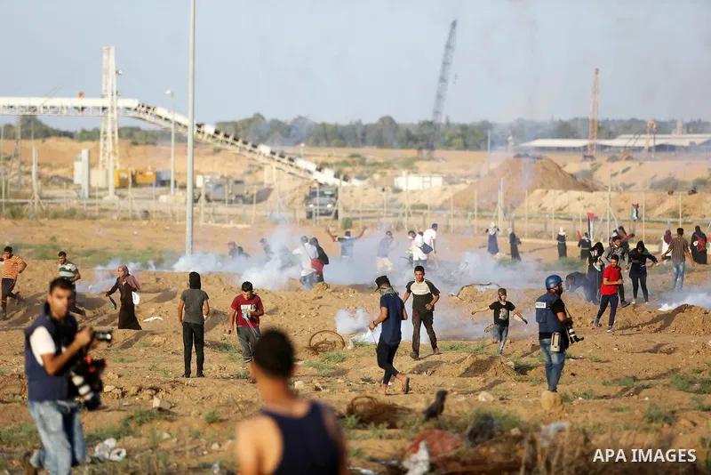 Protesters gather during a protest by Palestinian women where Palestinians demand the right to return to their homeland along the border with Israel east of Gaza City on July 3, 2018. Photo by Ashraf Amra