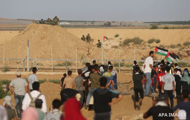 Protesters gather during a protest by Palestinian women where Palestinians demand the right to return to their homeland along the border with Israel east of Gaza City on July 3, 2018. Photo by Ashraf Amra