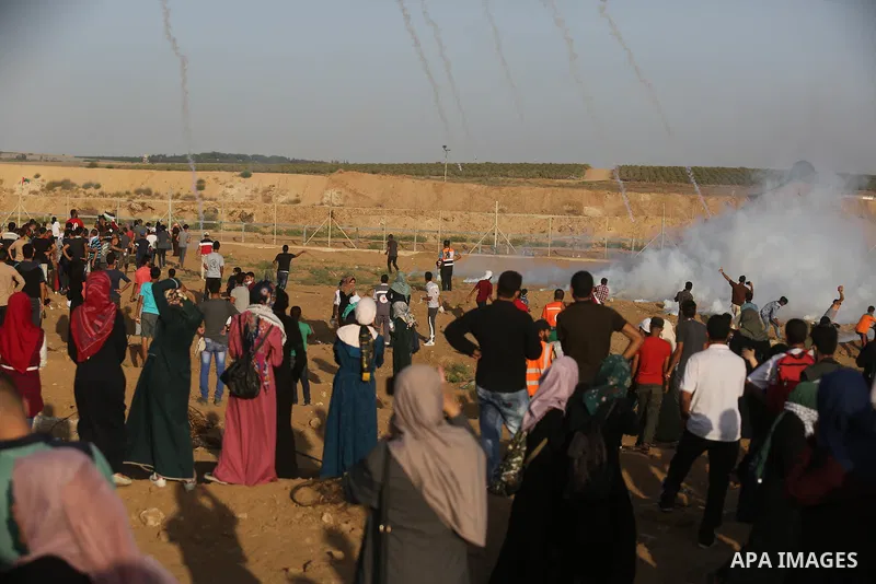 Protesters gather during a protest by Palestinian women where Palestinians demand the right to return to their homeland along the border with Israel east of Gaza City on July 3, 2018. Photo by Ashraf Amra