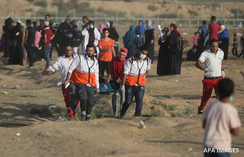 Protesters gather during a protest by Palestinian women where Palestinians demand the right to return to their homeland along the border with Israel east of Gaza City on July 3, 2018. Photo by Ashraf Amra