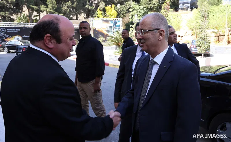 Palestinian Prime Minister, Rami Hamdallah, attends the launch of the report of the national team to assess the risks of the crimes of money laundering and terrorist financing, in the West bank city of Ramallah, on July...