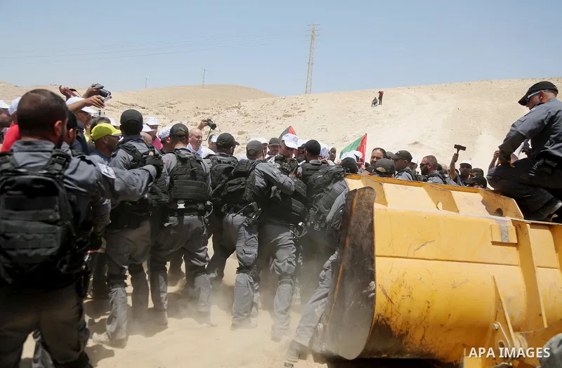 Israeli policemen scuffle with Palestinian demonstrators in the Bedouin village of al-Khan al-Ahmar east of Jerusalem in the occupied West Bank on July 4, 2018. Residents and activists voiced concern today that Israel is...