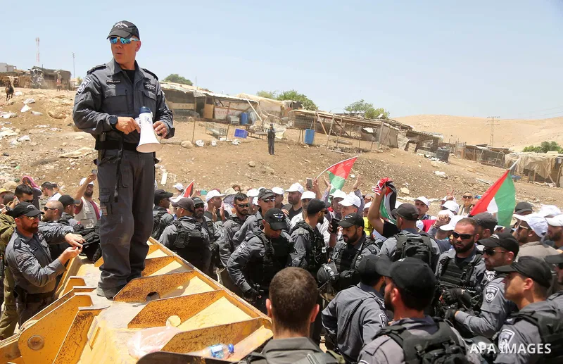 Israeli policemen scuffle with Palestinian demonstrators in the Bedouin village of al-Khan al-Ahmar east of Jerusalem in the occupied West Bank on July 4, 2018. Residents and activists voiced concern today that Israel is...