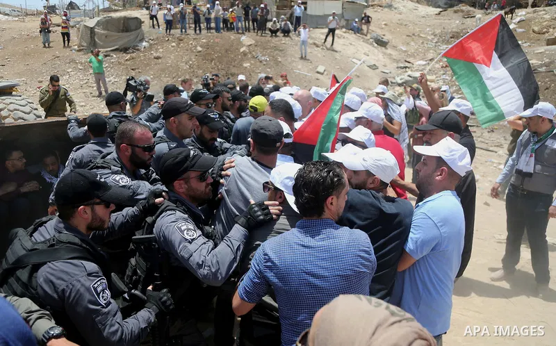 Israeli policemen scuffle with Palestinian demonstrators in the Bedouin village of al-Khan al-Ahmar east of Jerusalem in the occupied West Bank on July 4, 2018. Residents and activists voiced concern today that Israel is...