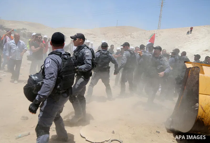 Israeli policemen scuffle with Palestinian demonstrators in the Bedouin village of al-Khan al-Ahmar east of Jerusalem in the occupied West Bank on July 4, 2018. Residents and activists voiced concern today that Israel is...