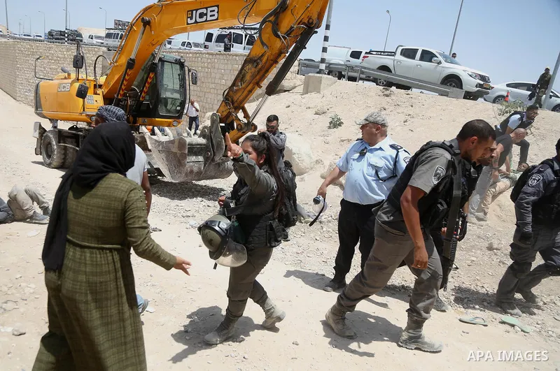 Israeli policemen scuffle with Palestinian demonstrators in the Bedouin village of al-Khan al-Ahmar east of Jerusalem in the occupied West Bank on July 4, 2018. Residents and activists voiced concern today that Israel is...