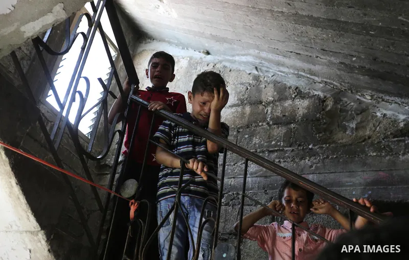 Relatives of Palestinian Mahmoud al-Ghrabli ,16, who died of wounds he sustained during clashes with Israeli troops, mourn during his funeral in Gaza city on July 5, 2018. Photo by Ashraf Amra