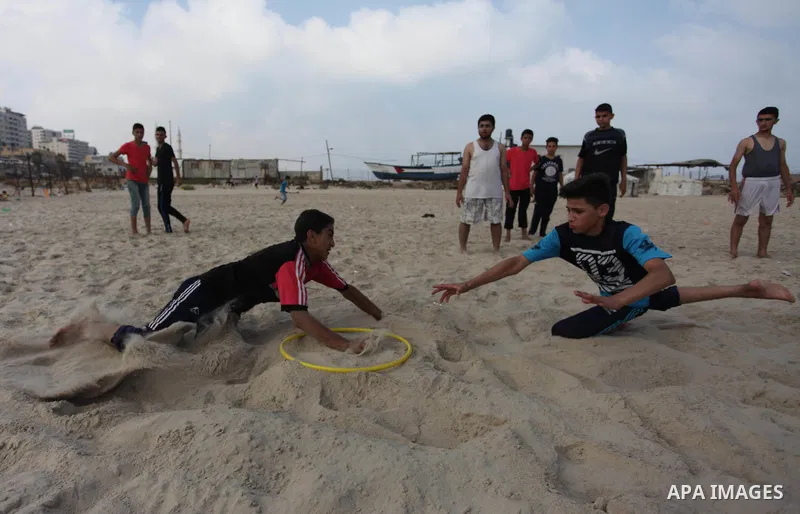Palestinians enjoy their time at the sea coast of Gaza City, July 06, 2018. Photo by Mahmoud Ajour