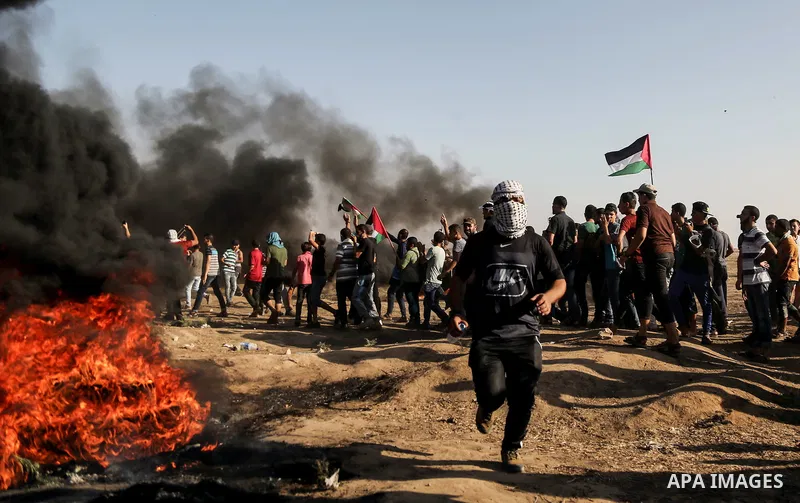 Palestinian protesters gather during clashes with Israeli troops in tents protest where Palestinian demand the right to return to their homeland at the Israel-Gaza border, in east of Gaza City on July 6, 2018. Photo by D...