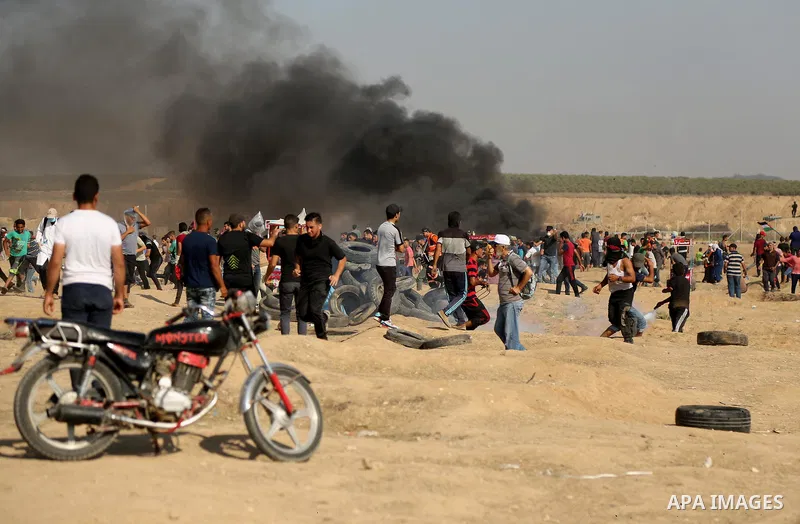 Palestinian protesters gather during clashes with Israeli troops in tents protest where Palestinian demand the right to return to their homeland at the Israel-Gaza border, in east of Gaza City on July 6, 2018. Photo by D...