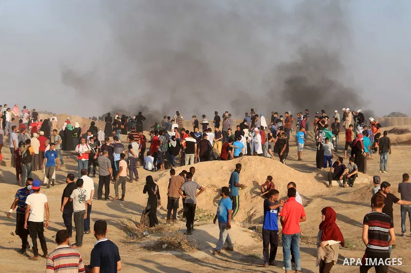 Palestinian protesters gather during clashes with Israeli troops in tents protest where Palestinian demand the right to return to their homeland at the Israel-Gaza border, in al-Bureij in the center of Gaza Strip on July...