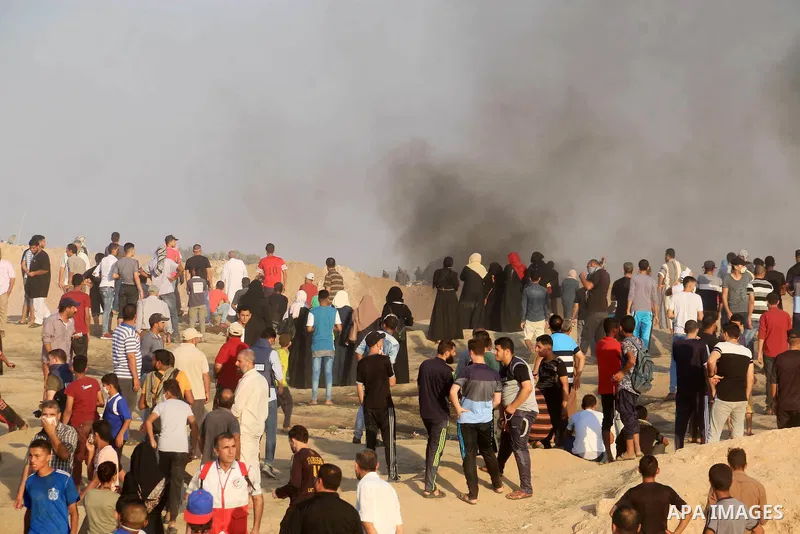 Palestinian protesters gather during clashes with Israeli troops in tents protest where Palestinian demand the right to return to their homeland at the Israel-Gaza border, in al-Bureij in the center of Gaza Strip on July...