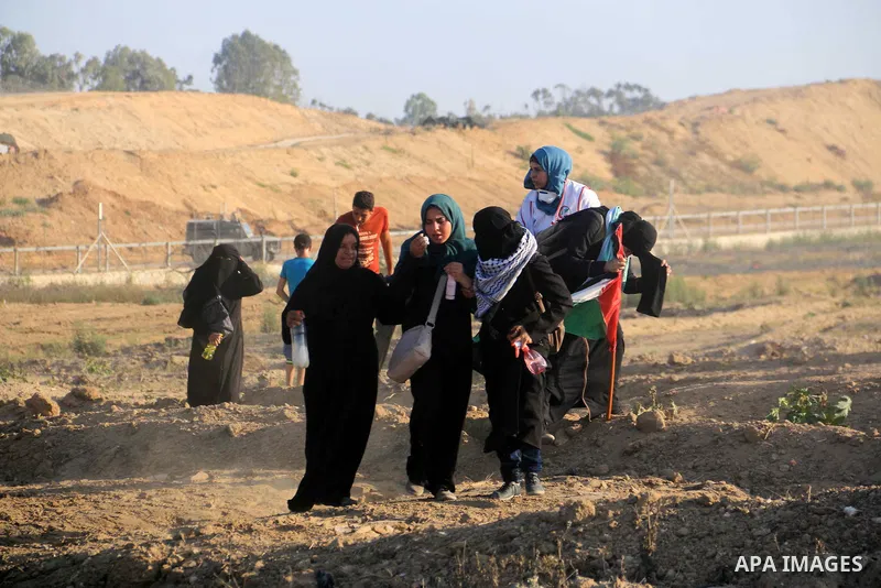 Palestinian protesters gather during clashes with Israeli troops in tents protest where Palestinian demand the right to return to their homeland at the Israel-Gaza border, in al-Bureij in the center of Gaza Strip on July...