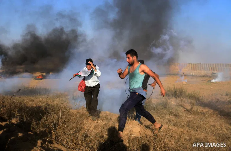 Palestinian protesters gather during clashes with Israeli troops in tents protest where Palestinian demand the right to return to their homeland at the Israel-Gaza border, in al-Bureij in the center of Gaza Strip on July...