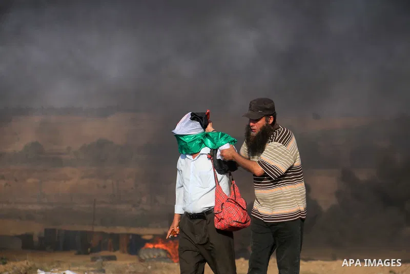 Palestinian protesters gather during clashes with Israeli troops in tents protest where Palestinian demand the right to return to their homeland at the Israel-Gaza border, in al-Bureij in the center of Gaza Strip on July...