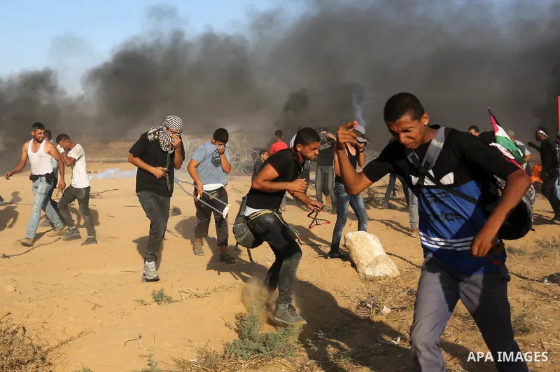 Palestinian protesters gather during clashes with Israeli troops in tents protest where Palestinian demand the right to return to their homeland at the Israel-Gaza border, in Khan Younis in the southern Gaza Strip on Jul...