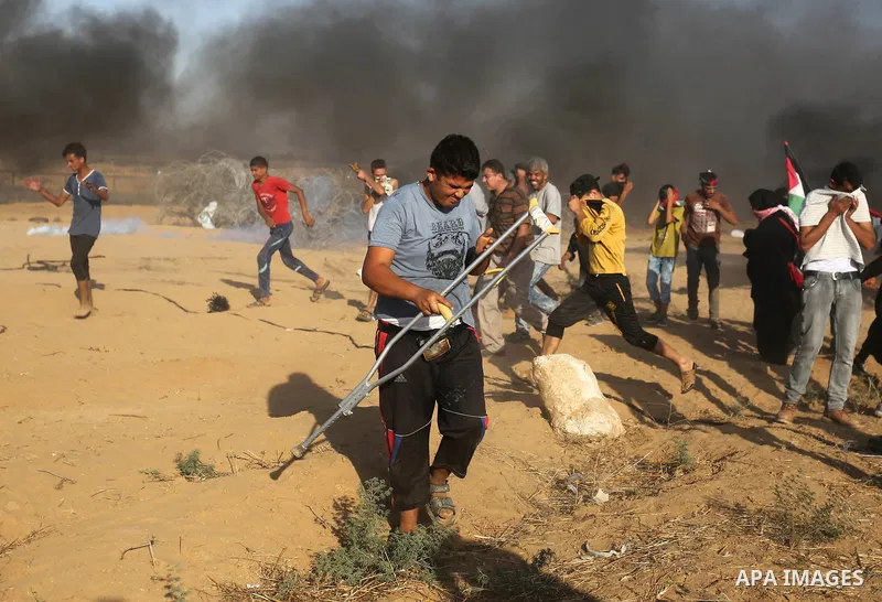 Palestinian protesters gather during clashes with Israeli troops in tents protest where Palestinian demand the right to return to their homeland at the Israel-Gaza border, in Khan Younis in the southern Gaza Strip on Jul...