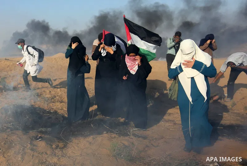 Palestinian protesters gather during clashes with Israeli troops in tents protest where Palestinian demand the right to return to their homeland at the Israel-Gaza border, in Khan Younis in the southern Gaza Strip on Jul...