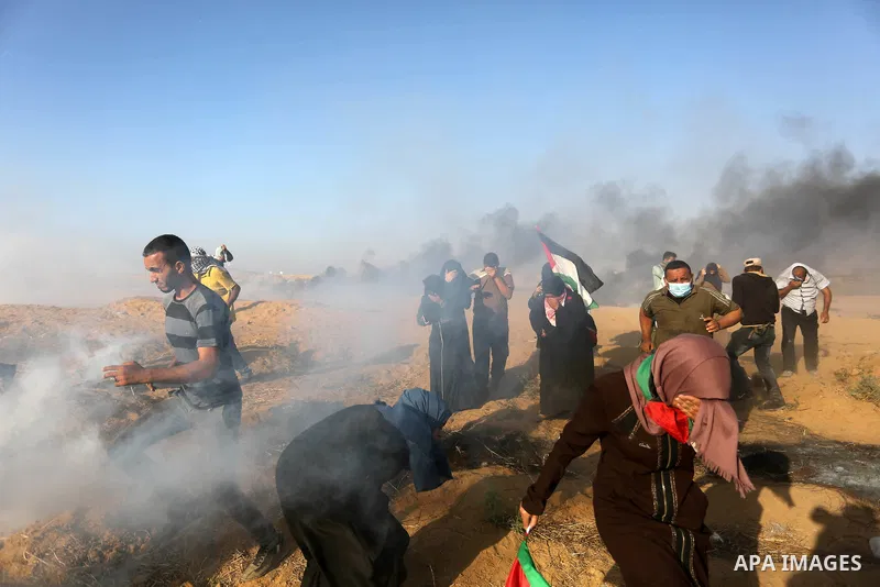 Palestinian protesters gather during clashes with Israeli troops in tents protest where Palestinian demand the right to return to their homeland at the Israel-Gaza border, in Khan Younis in the southern Gaza Strip on Jul...