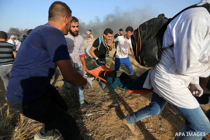 A wounded Palestinian protester is evacuated during clashes with Israeli troops in tents protest where Palestinian demand the right to return to their homeland at the Israel-Gaza border, in Khan Younis in the southern Ga...