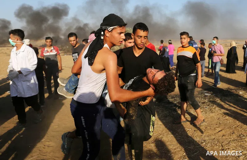 A wounded Palestinian protester is evacuated during clashes with Israeli troops in tents protest where Palestinian demand the right to return to their homeland at the Israel-Gaza border, in Khan Younis in the southern Ga...